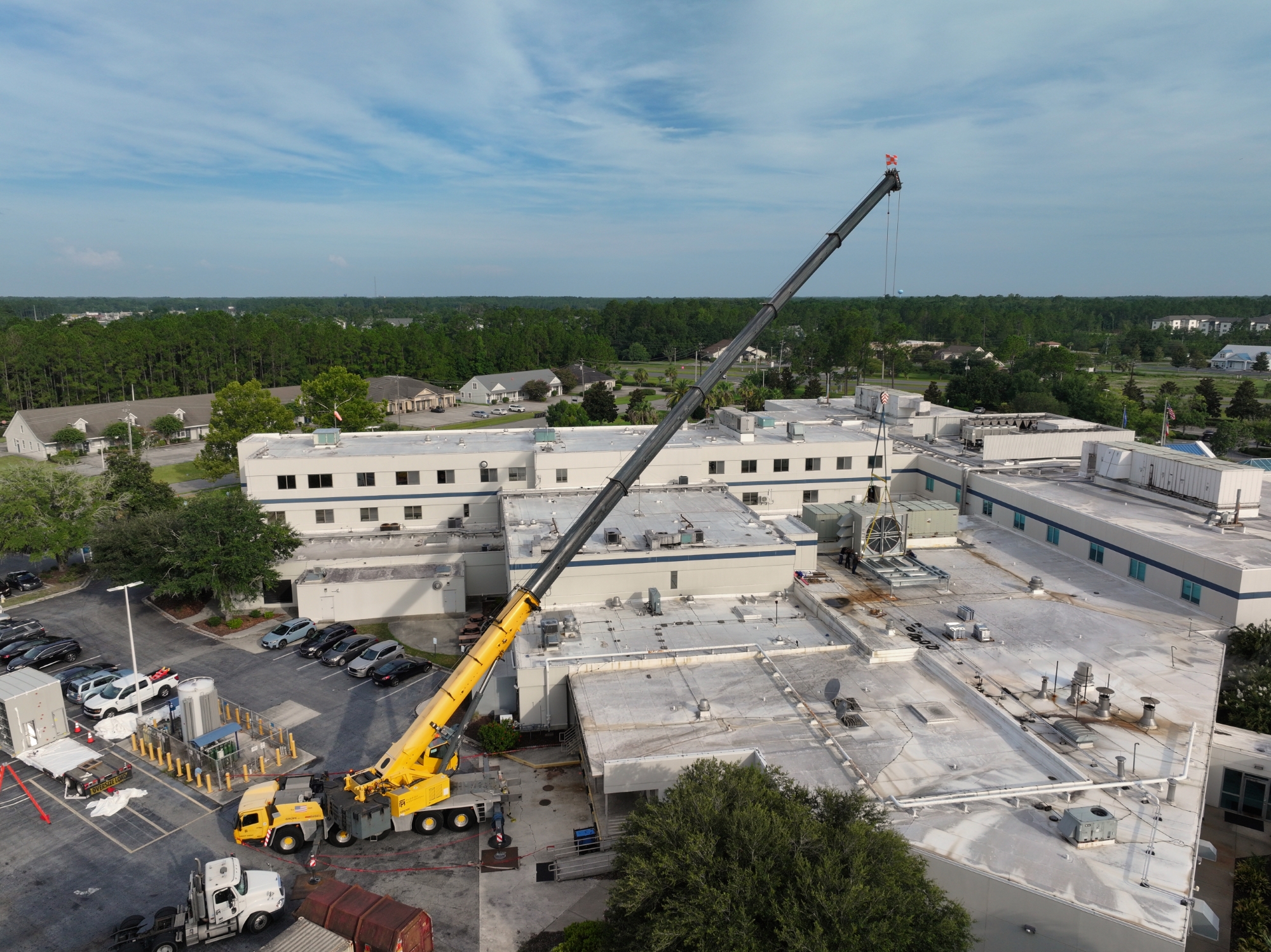 Crane lifting object over hospital