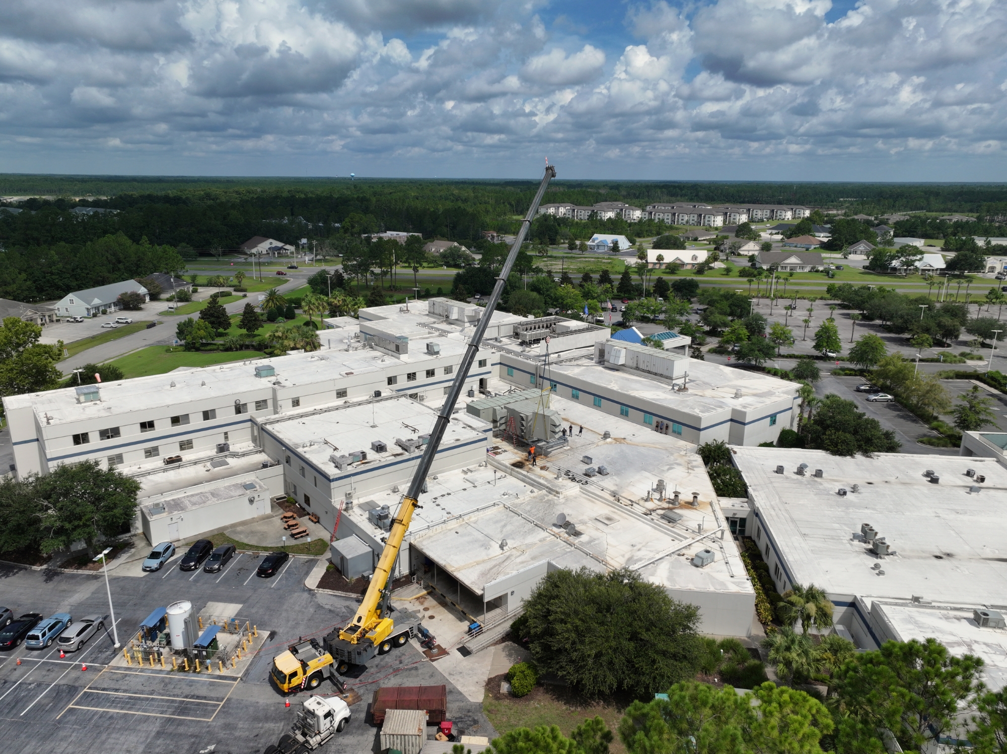 Crane lifting object over hospital